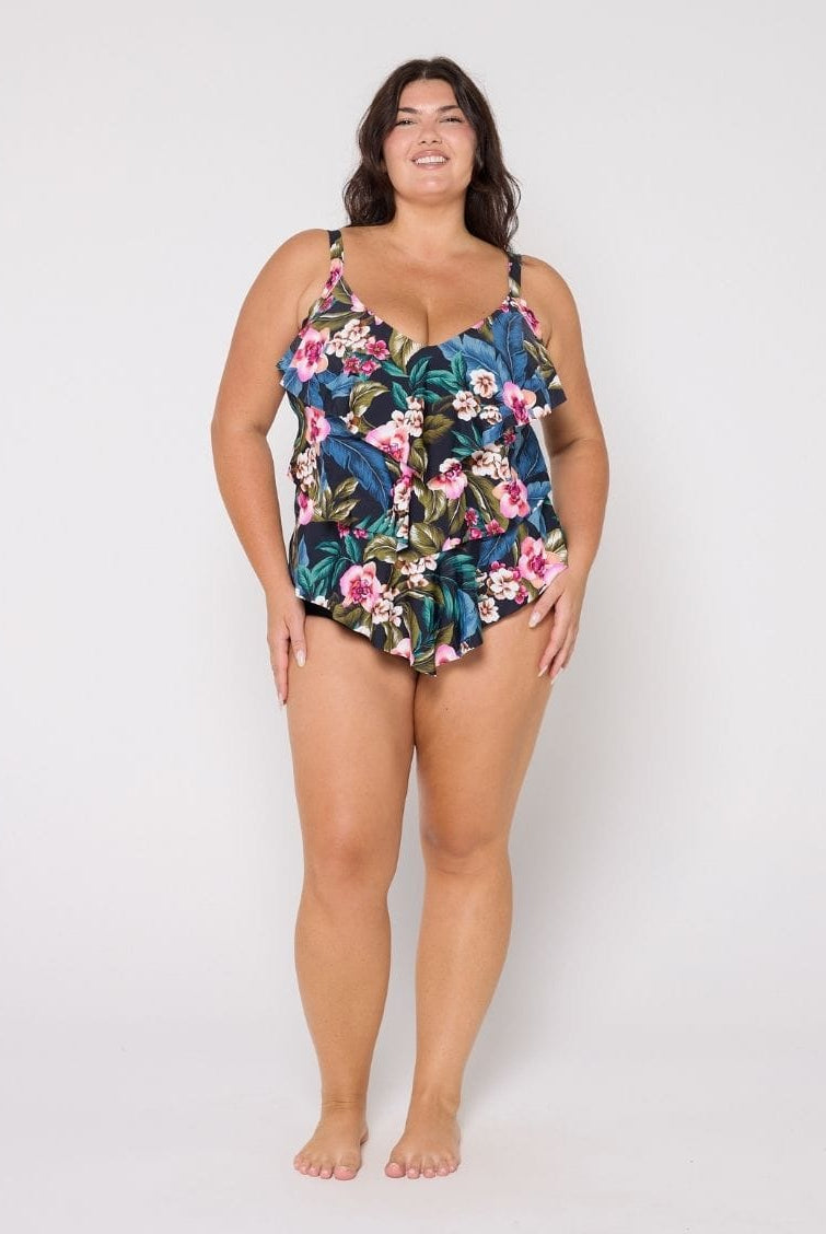 Woman wearing a floral swimsuit on a white background