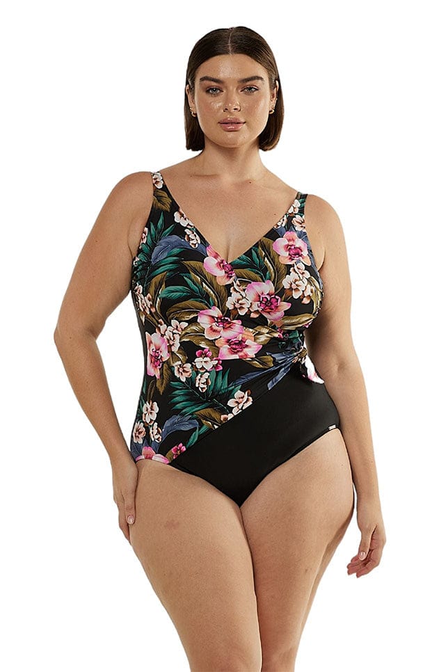 Model wearing tropical print crossover one piece