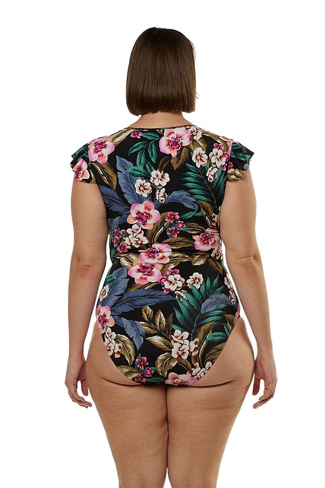 Brunette model showing back of tropical frill sleeve one piece
