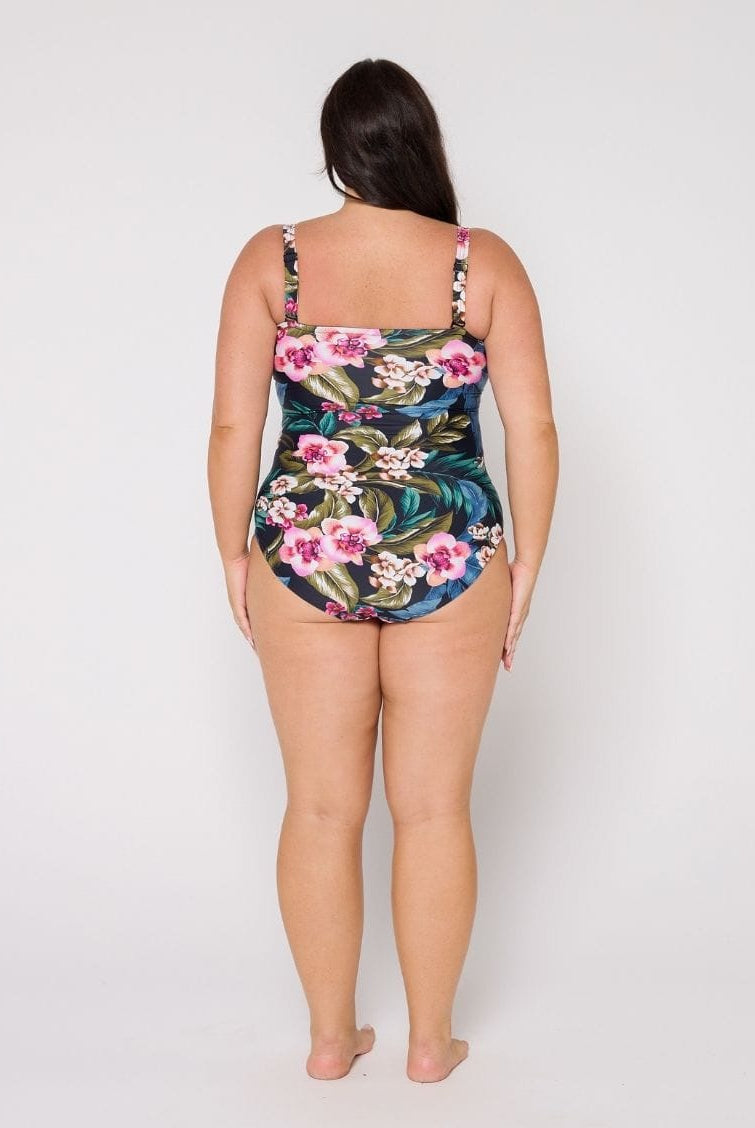 Woman wearing a floral swimsuit on a white background with removable straps