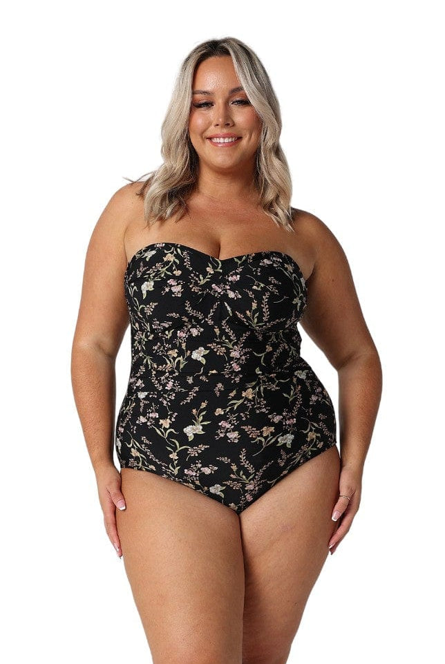 Model wearing black floral strapless bandeau one piece