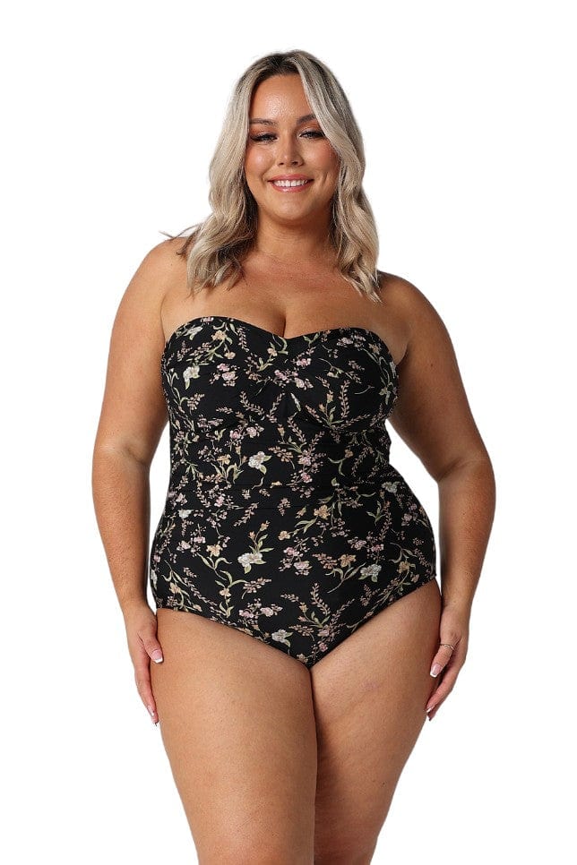 Model wearing black floral strapless bandeau one piece