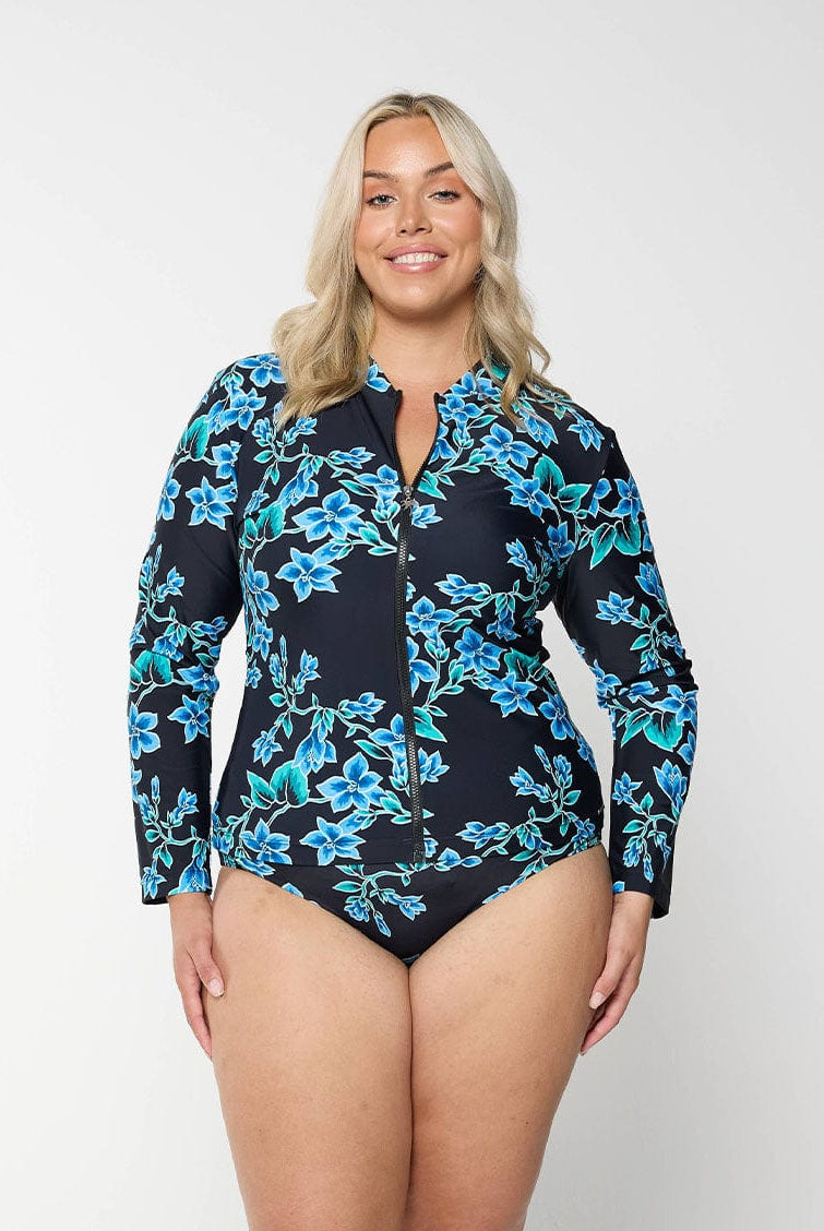 Blonde model wears full coverage long sleeve rashie in blue floral design