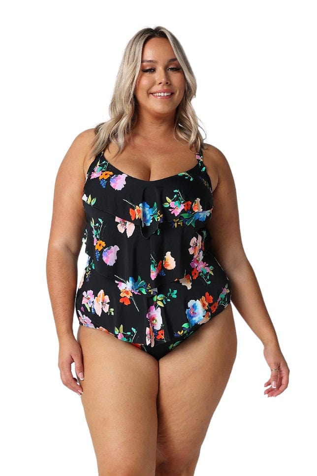 Model wearing black floral ruffle swimsuit