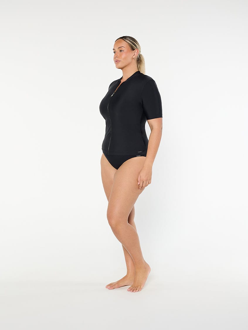 Person wearing a black swimsuit on a white background