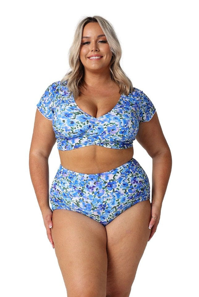 Model wearing blue and white floral wrap bikini top and high waisted bottoms