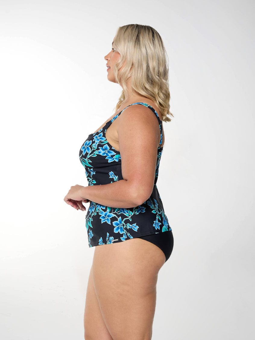 Blonde model shows side shot of blue floral tankini top with adjustable straps