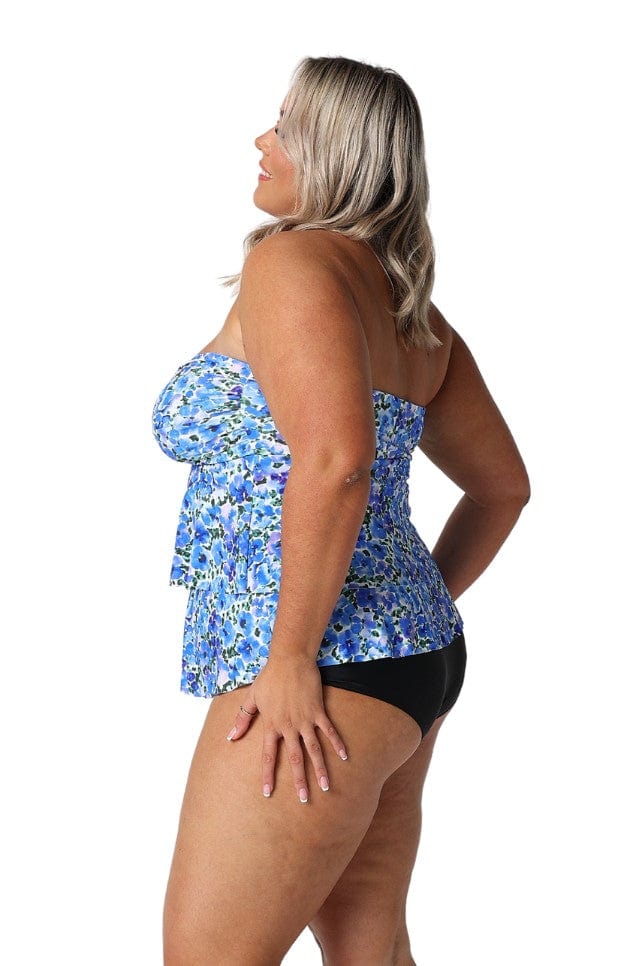 Model showing side of blue floral strapless tankini top