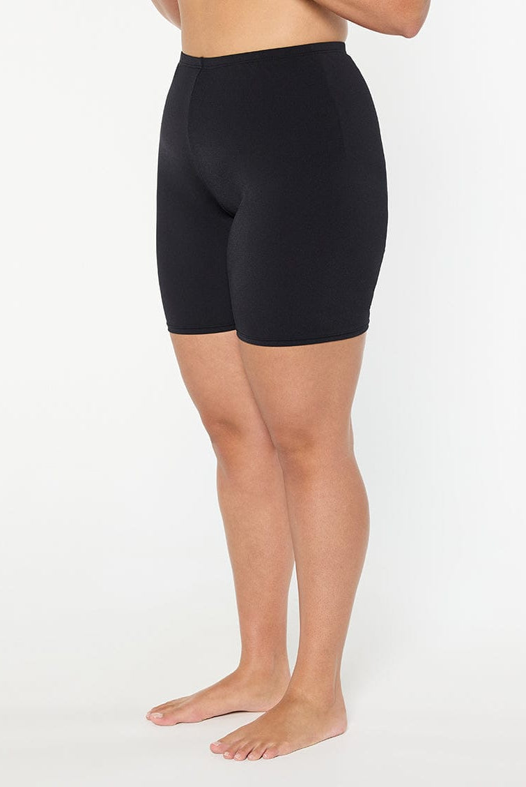 Person wearing black shorts on a white background