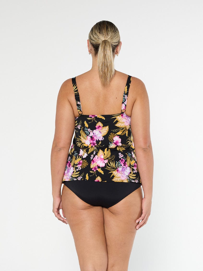 Blonde model shows the back of chlorine resistant pink and black floral tankini top with adjustable straps