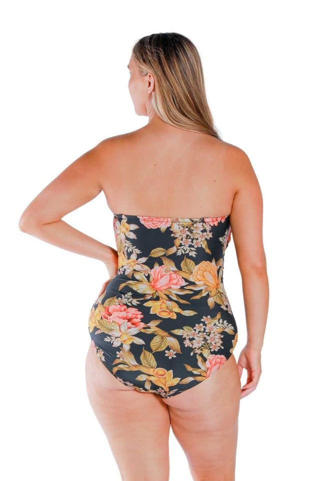 Model wearing orange and yellow floral and black printed twist front bandeau one piece