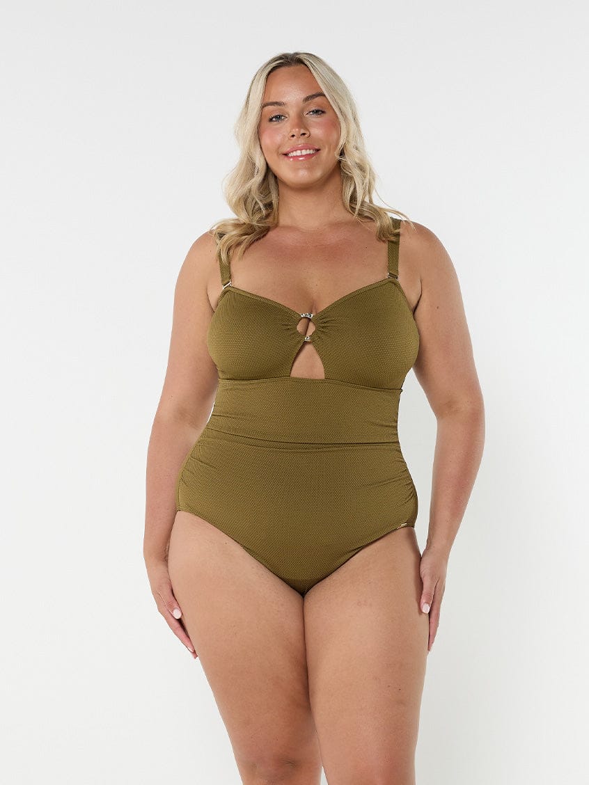 Blonde model wears khaki bandeau one piece swimsuit with removable straps