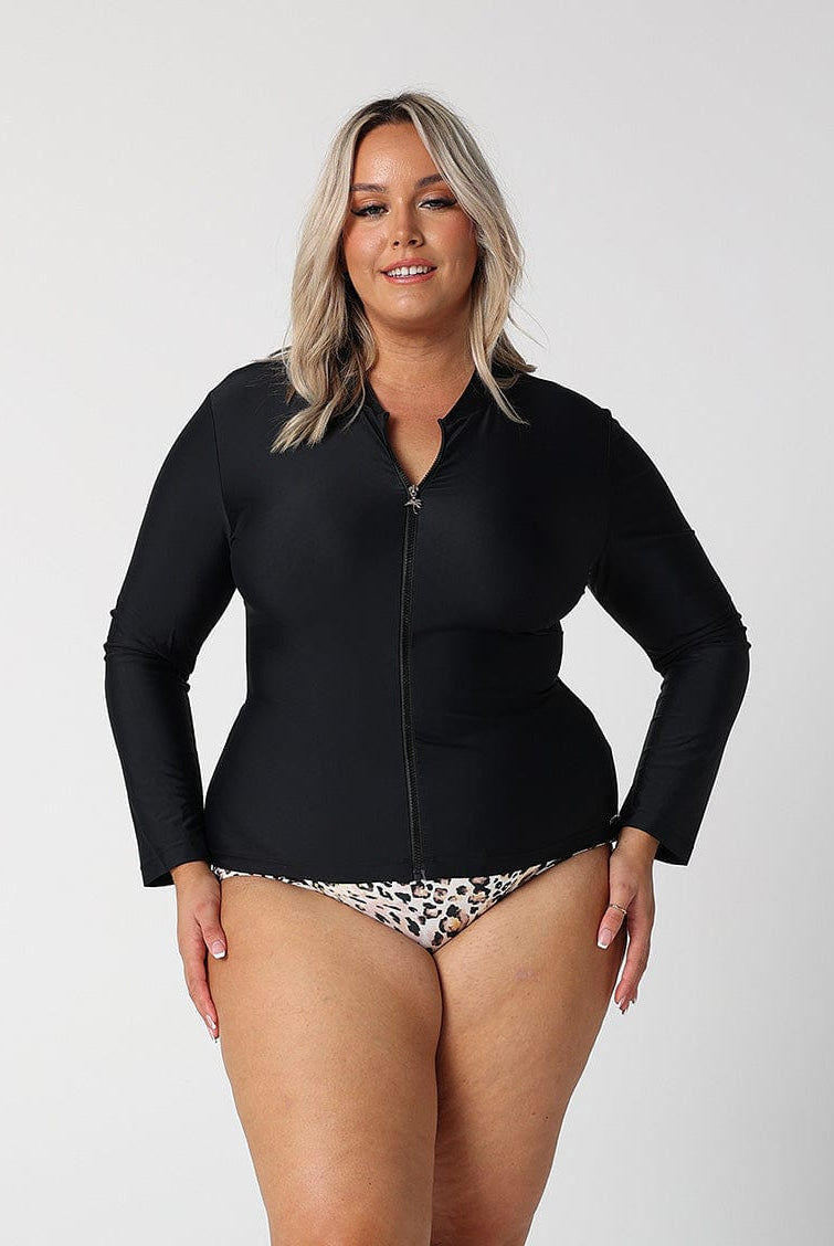 brunette model wears plain black long sleeve rash vest