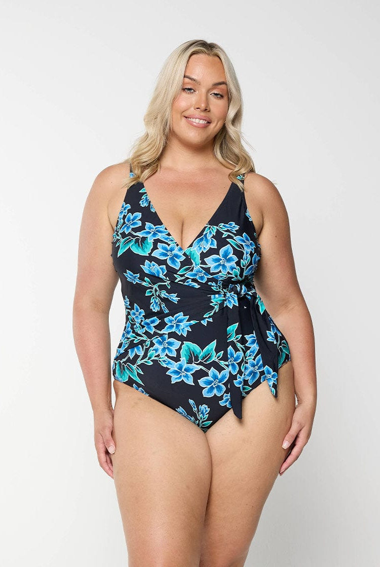 Blonde model wearing blue floral v neck one piece with tie side crossover