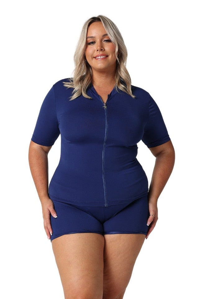 Model wearing navy short sleeve zip front rash vest