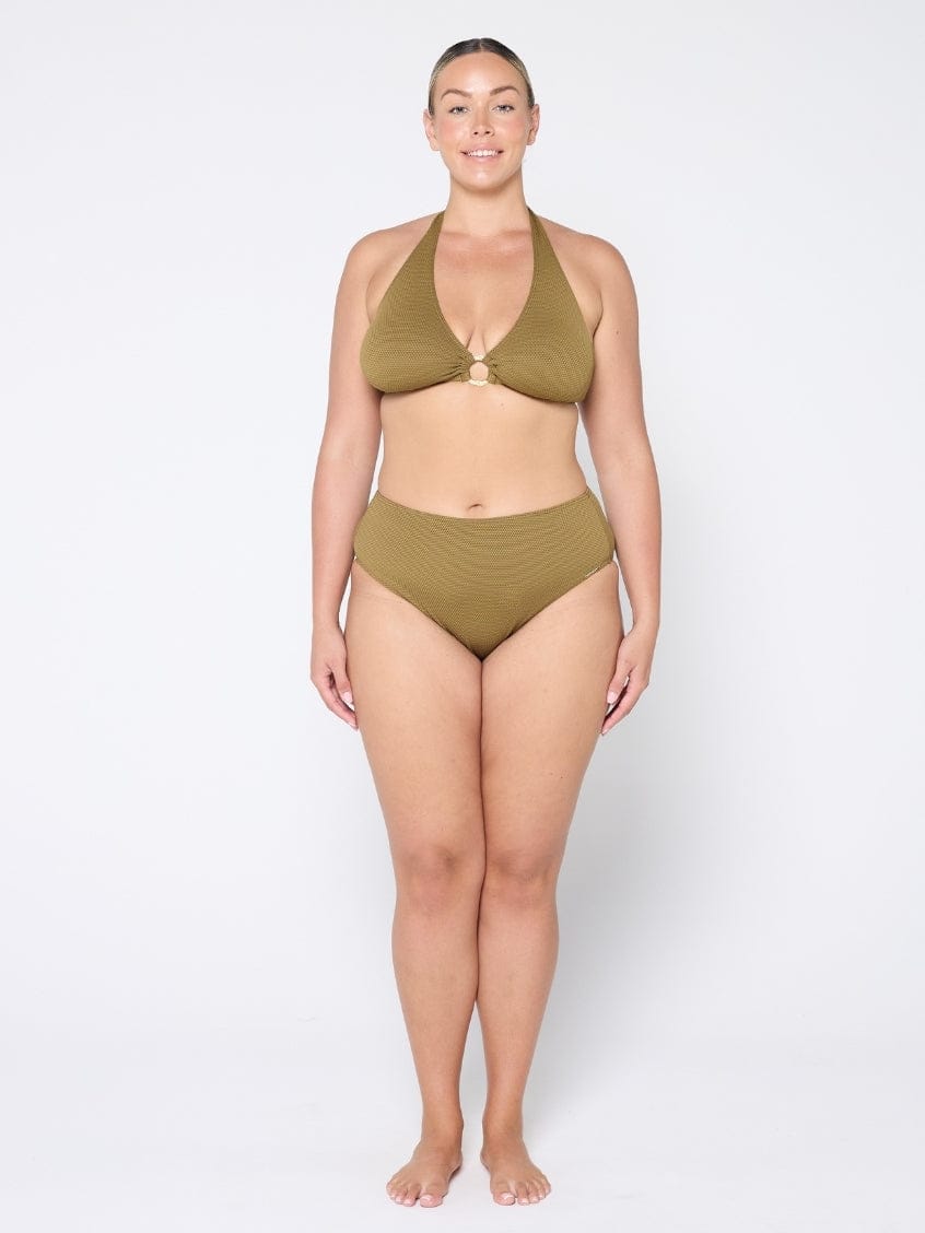 Woman wearing a green bikini set on a white background