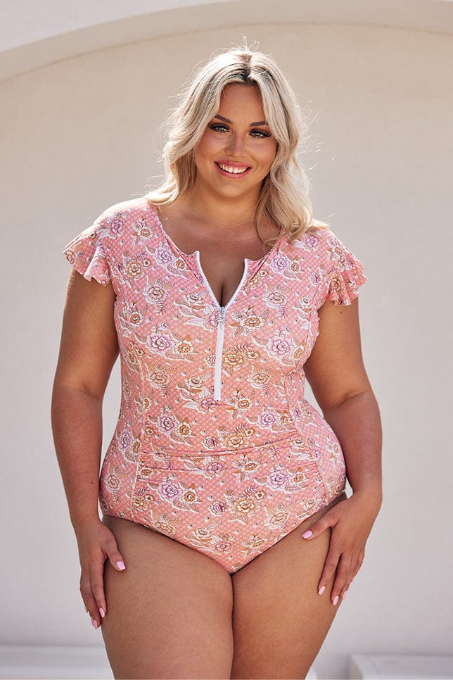 Blonde model wearing blush pink floral frill sleeve one piece