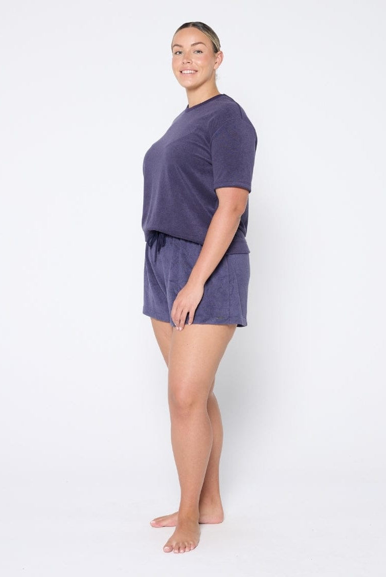 Woman wearing a navy terry set on a white background
