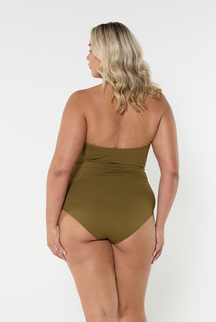 Blonde model wears strapless halter neck one piece in flattering textured olive fabric