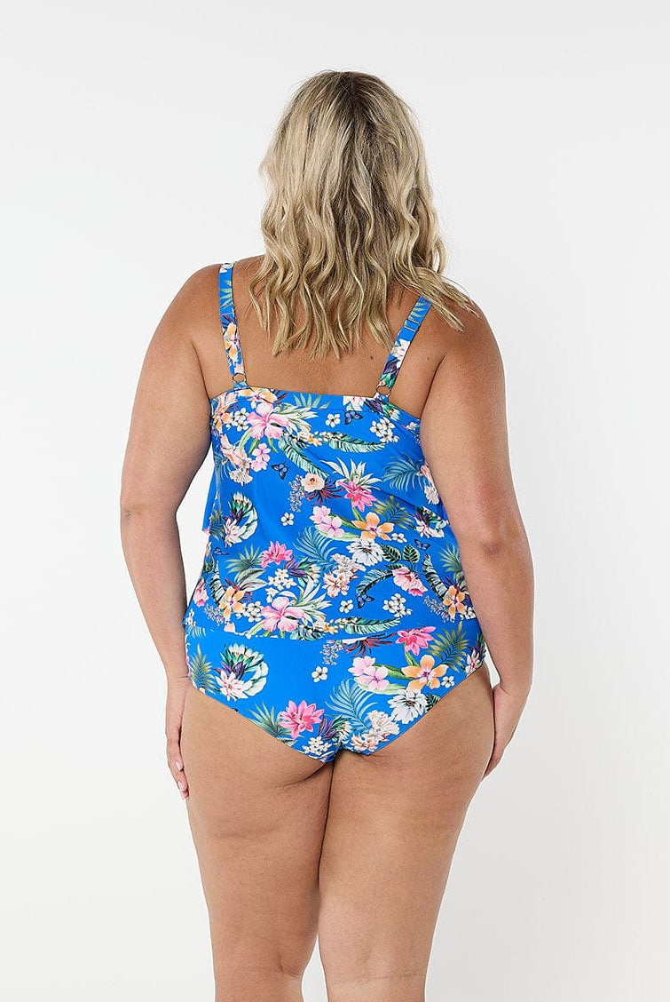 Blonde model shows back of floral blue 3 tier tankini top with shelf bra and adjustable straps