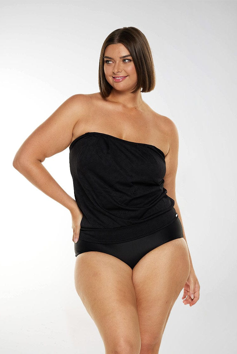 Woman wearing a black strapless tankini top with textured fabric
