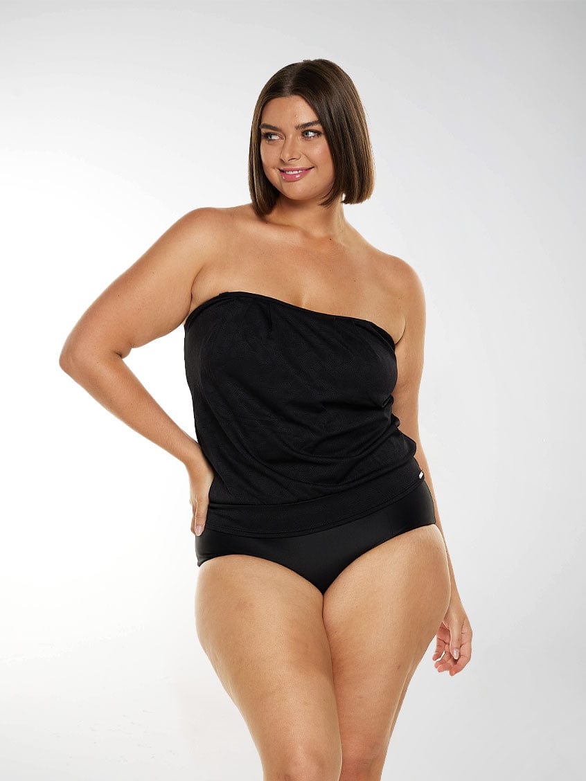 Woman wearing a black strapless tankini top with textured fabric