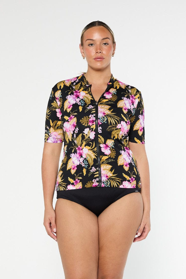 Blonde model shows pink and gold floral pool proof rashie with full front zip and short sleeves