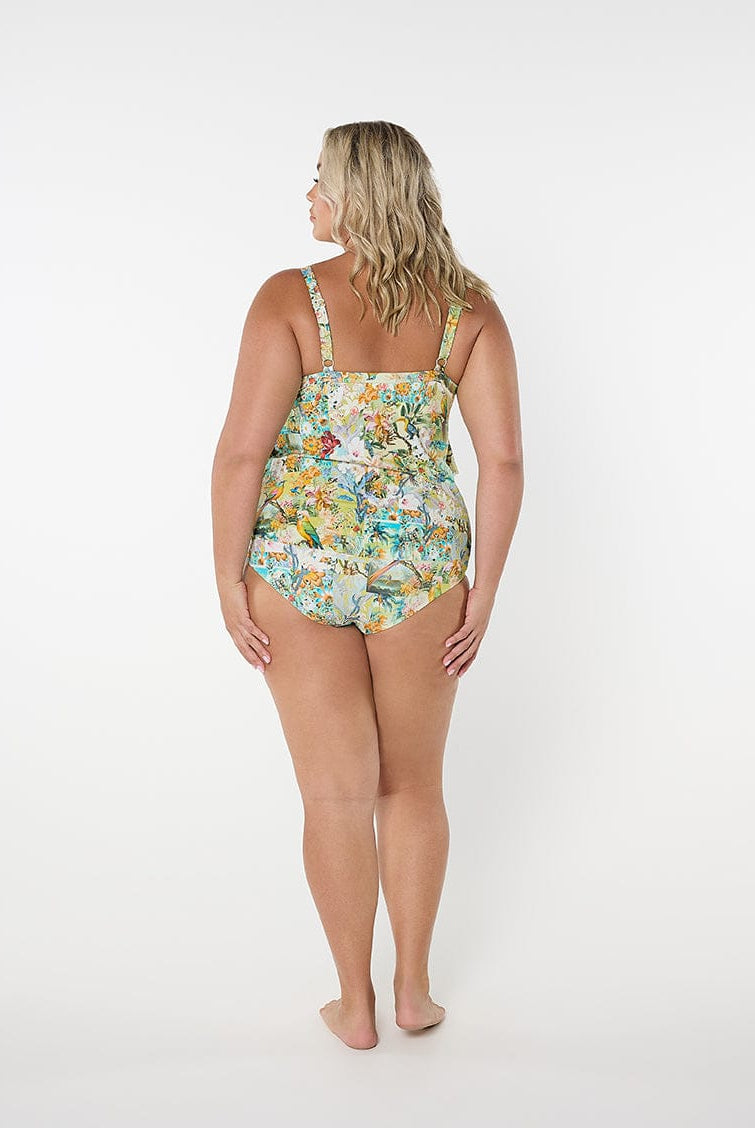 Woman wearing a floral one-piece swimsuit on a white background