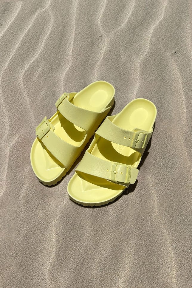 Yellow womens sandal on beach