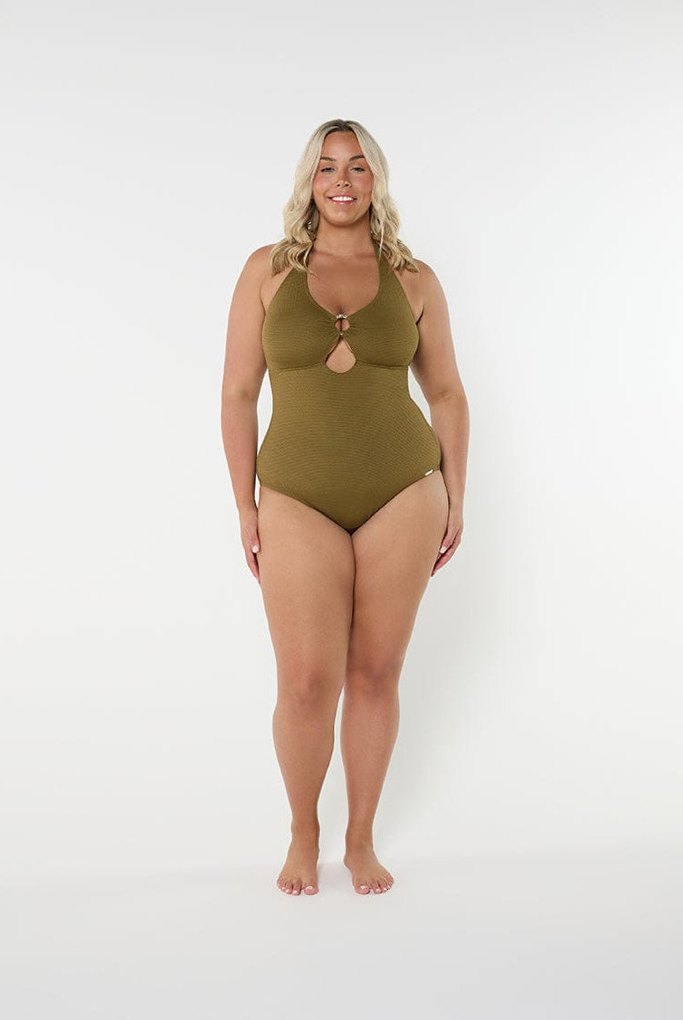 Woman wearing a green swimsuit on a white background