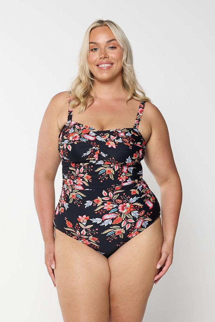 model wearing black and red floral one piece