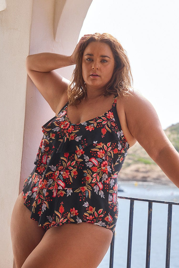 model wearing black and red floral three tier one piece