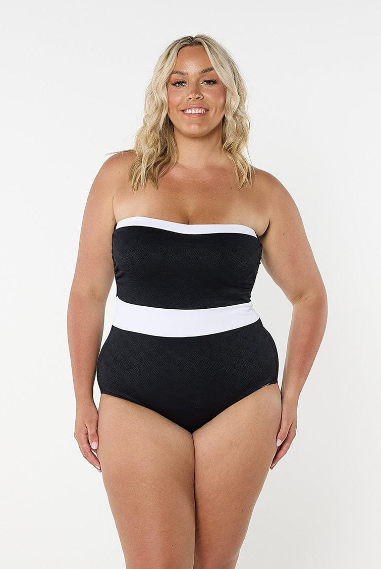 model wearing black and white strapless one piece