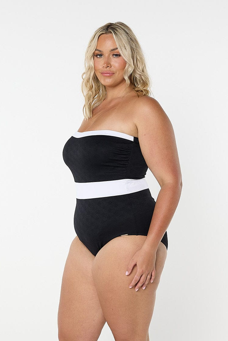 model wearing black and white bandeau one piece