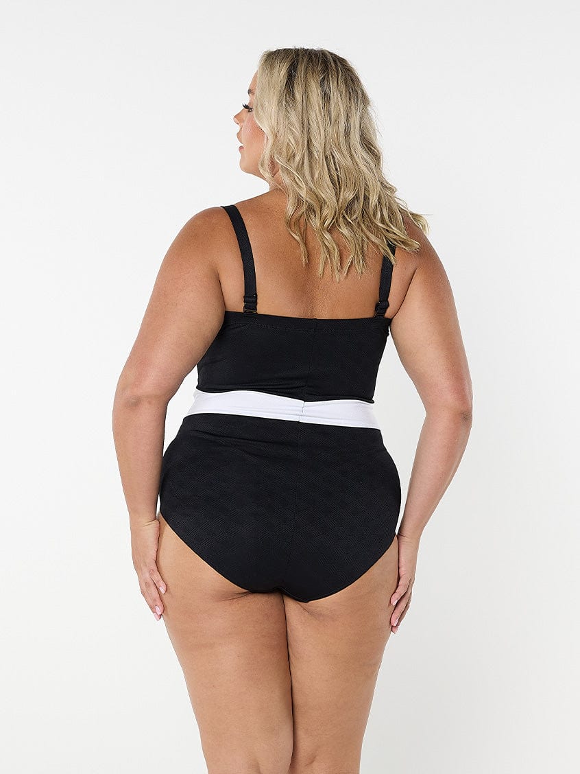 model showing back of black and white textured swimsuit