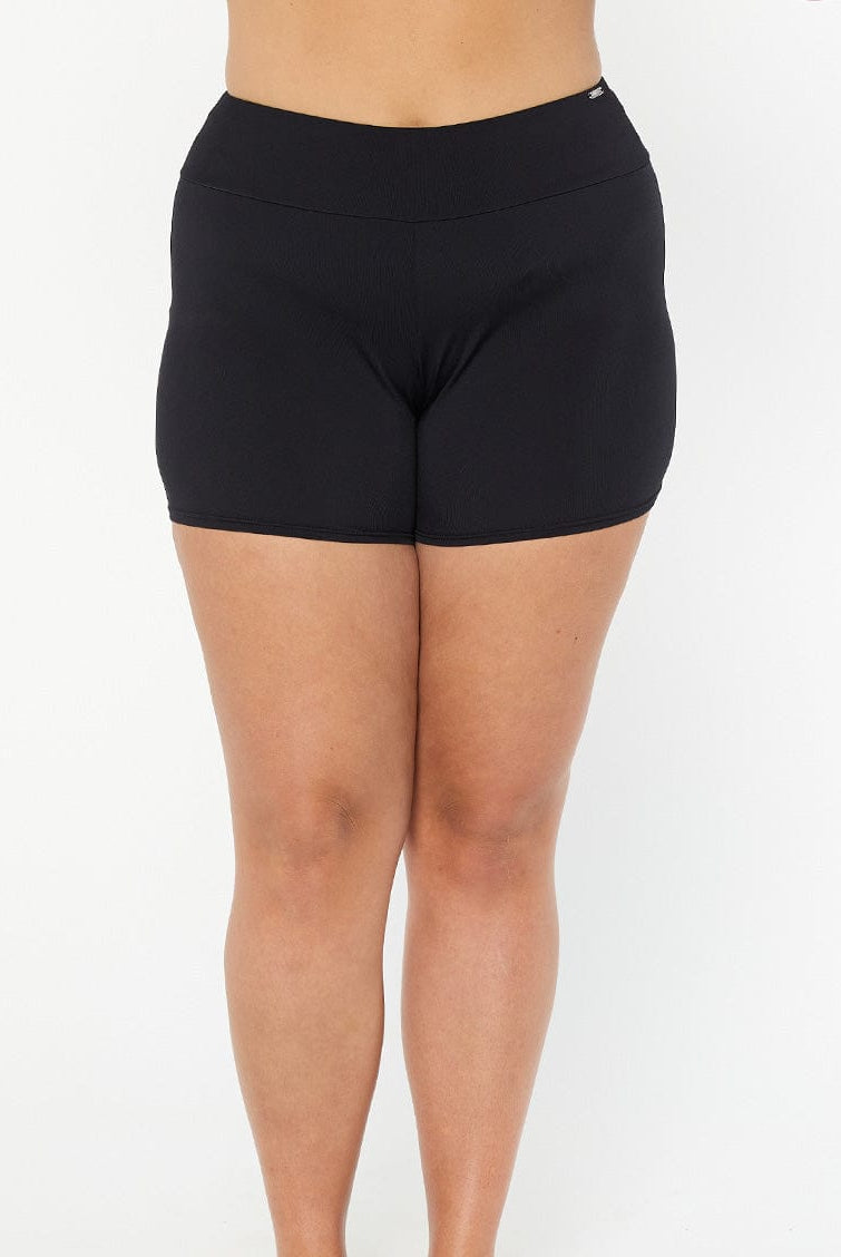 model wearing black boyleg swim shorts