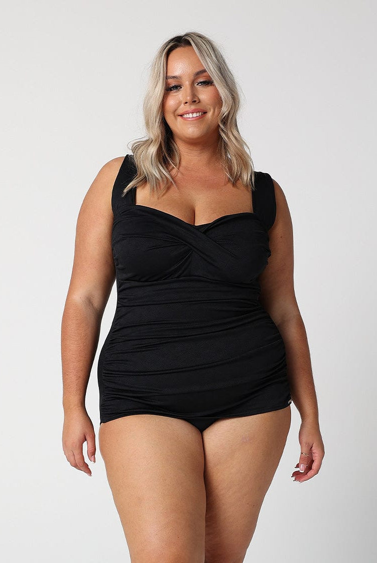 model wearing black ruched retro one piece