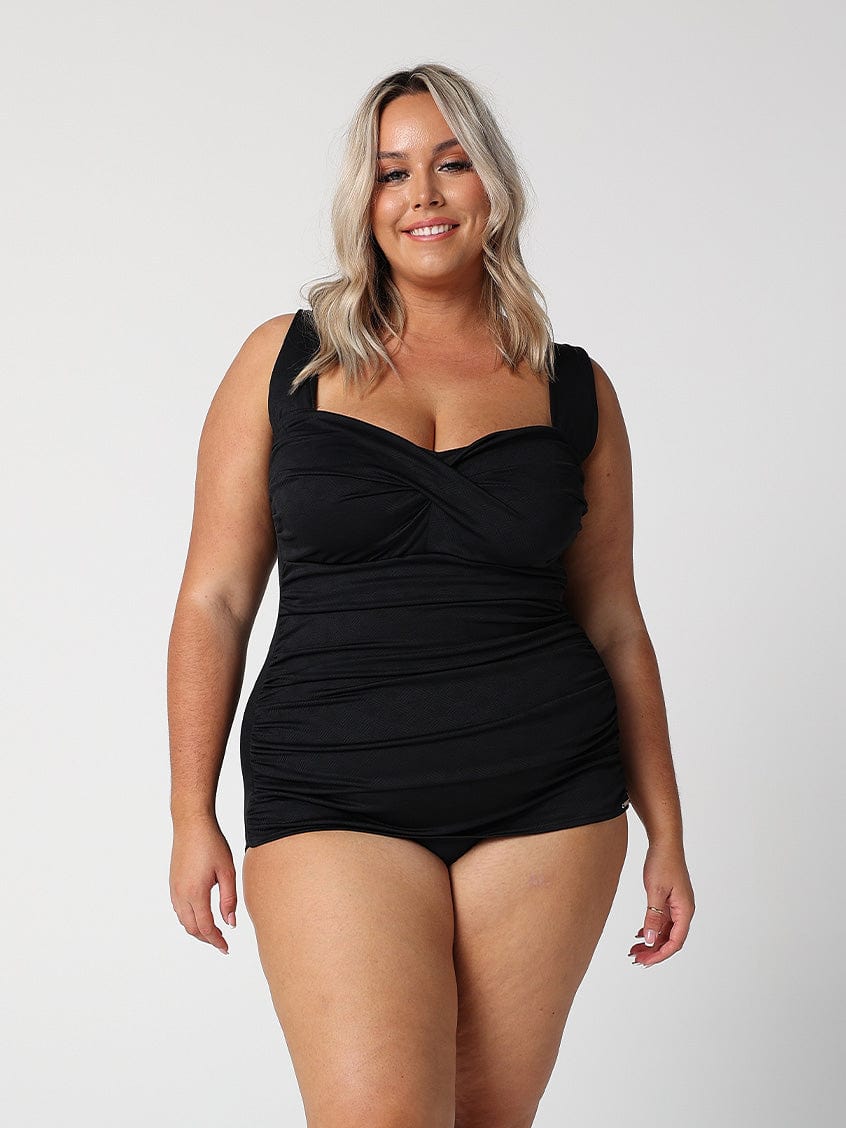 model wearing black ruched retro one piece