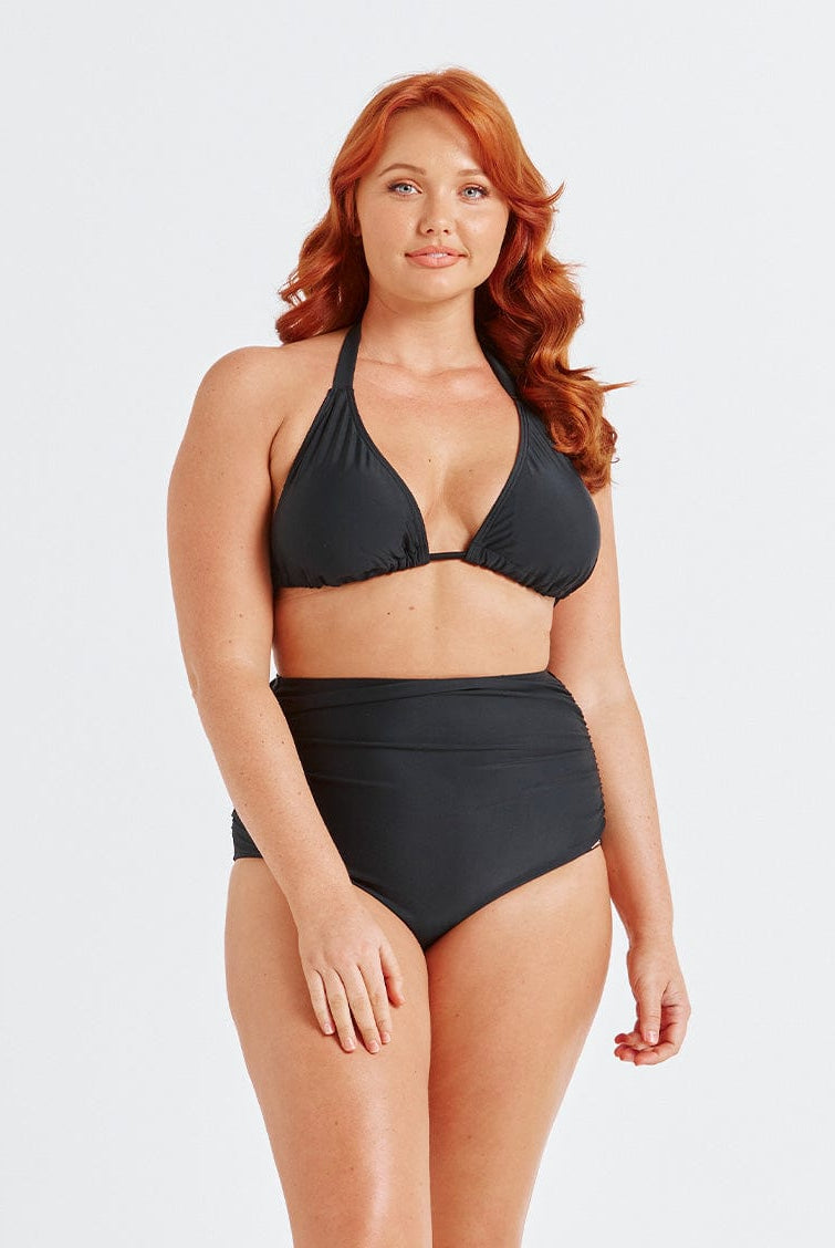 model wearing black ruched swim bottom with matching bikini top