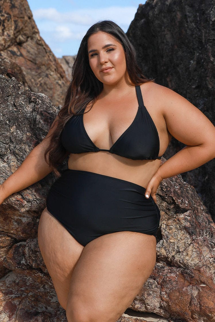 model wearing black high waisted ruched swim pant