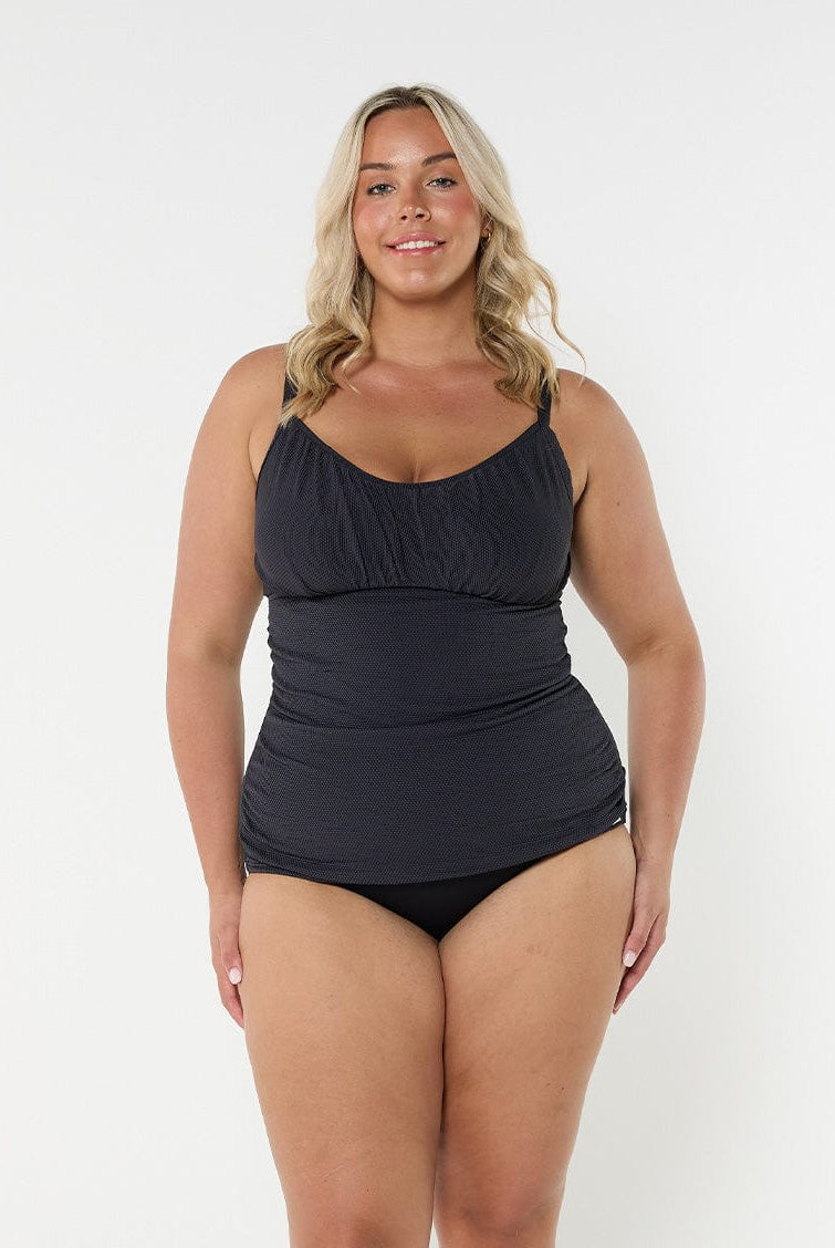 Blonde model wearing black honey comb textured underwire tankini