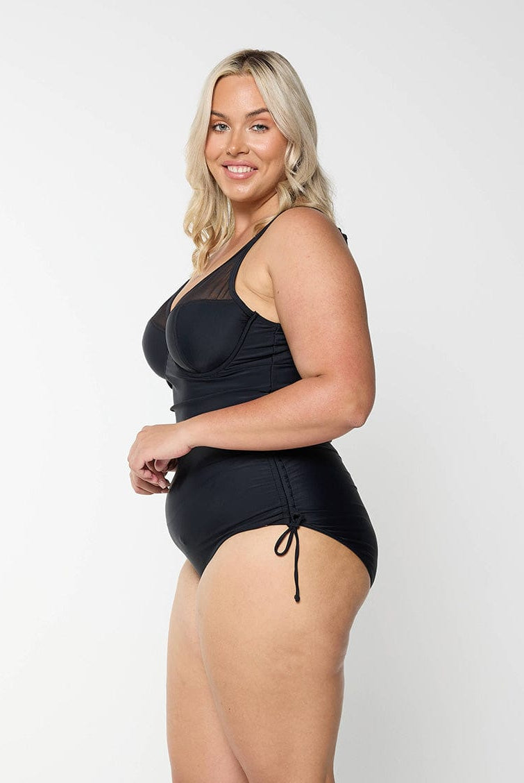 model wearing black mesh one piece swimsuit