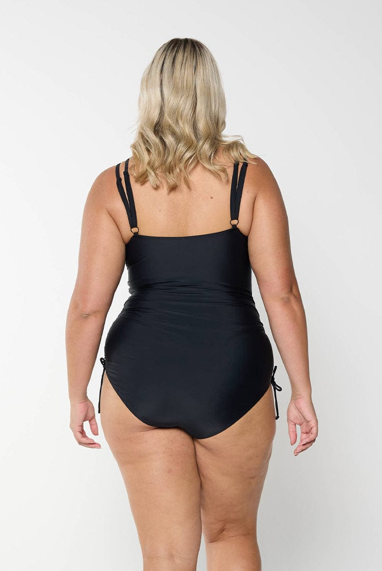 model showing back of black swimsuit with tie sides
