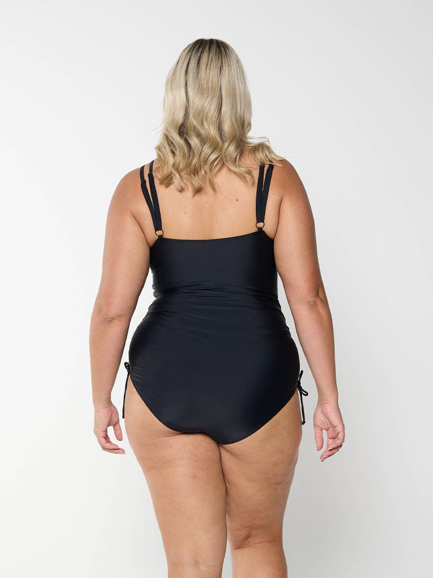 model showing back of black swimsuit with tie sides