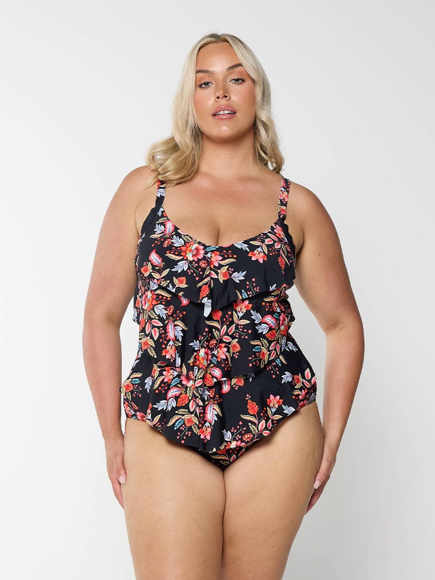 model wearing black and red floral women's one piece swimsuit