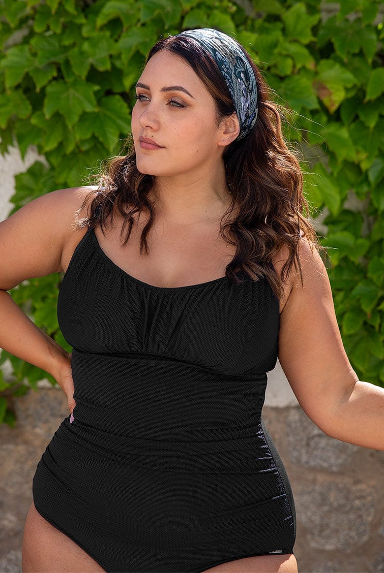 model wearing black textured women's swimsuit