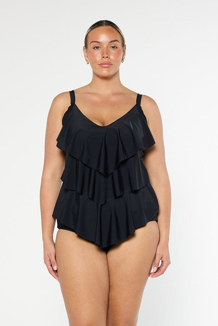 model wearing black three tier tankini top