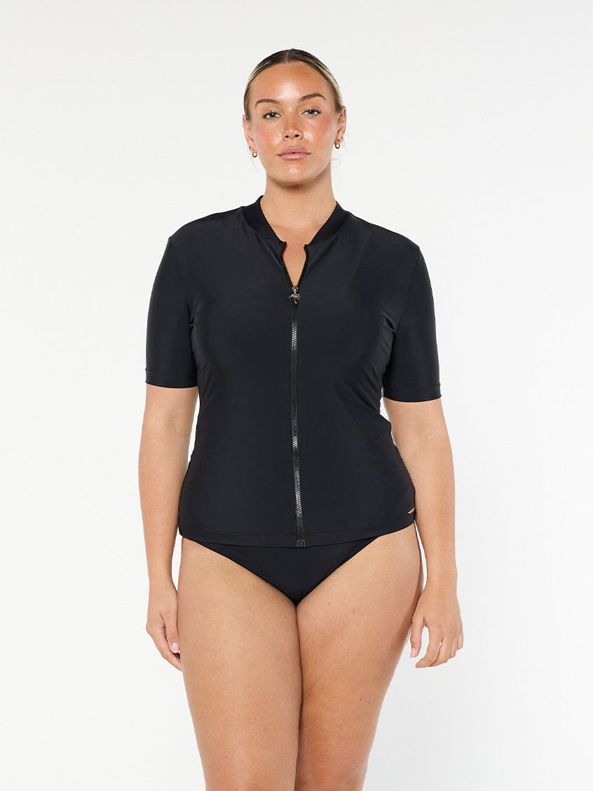model wearing black short sleeve rash vest