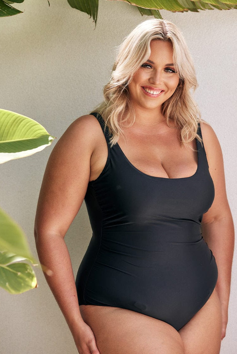 model wearing black women's swimsuit