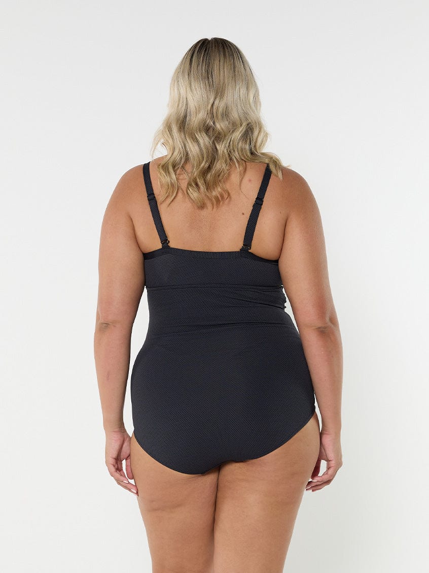 model showing back of black honey comb underwire one piece